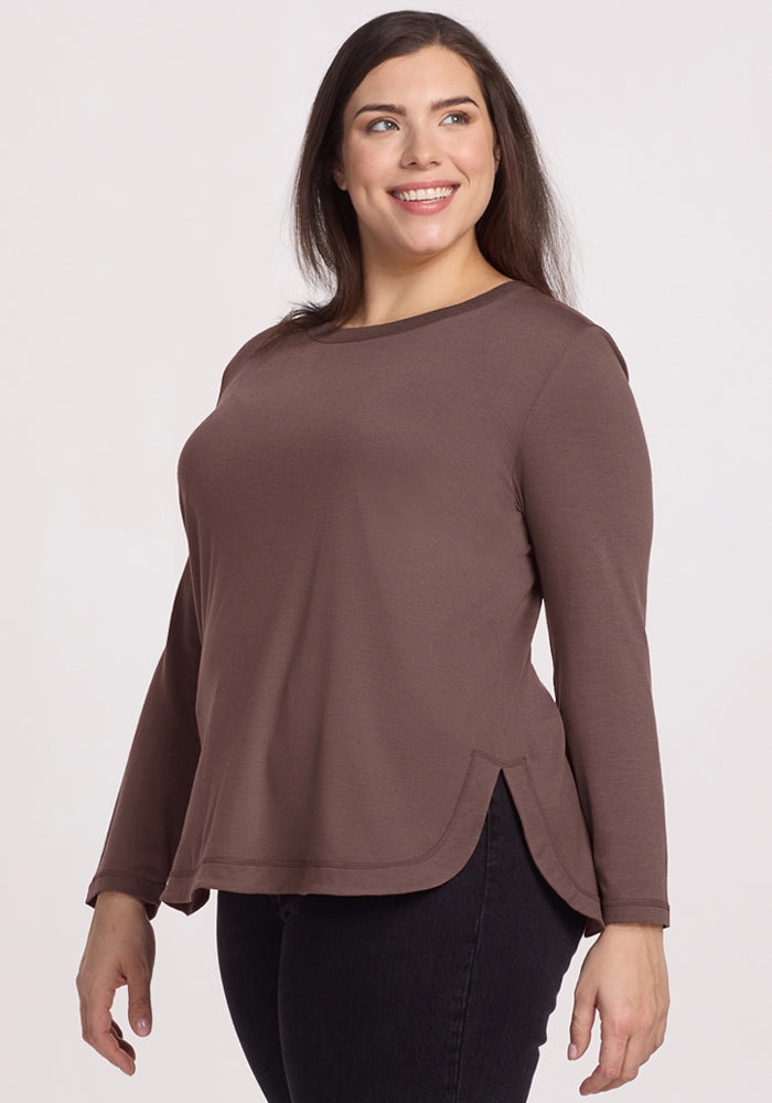 Woman smiling in the Woolx Hazel Tunic - Peppercorn and black jeans, standing against a plain light background.