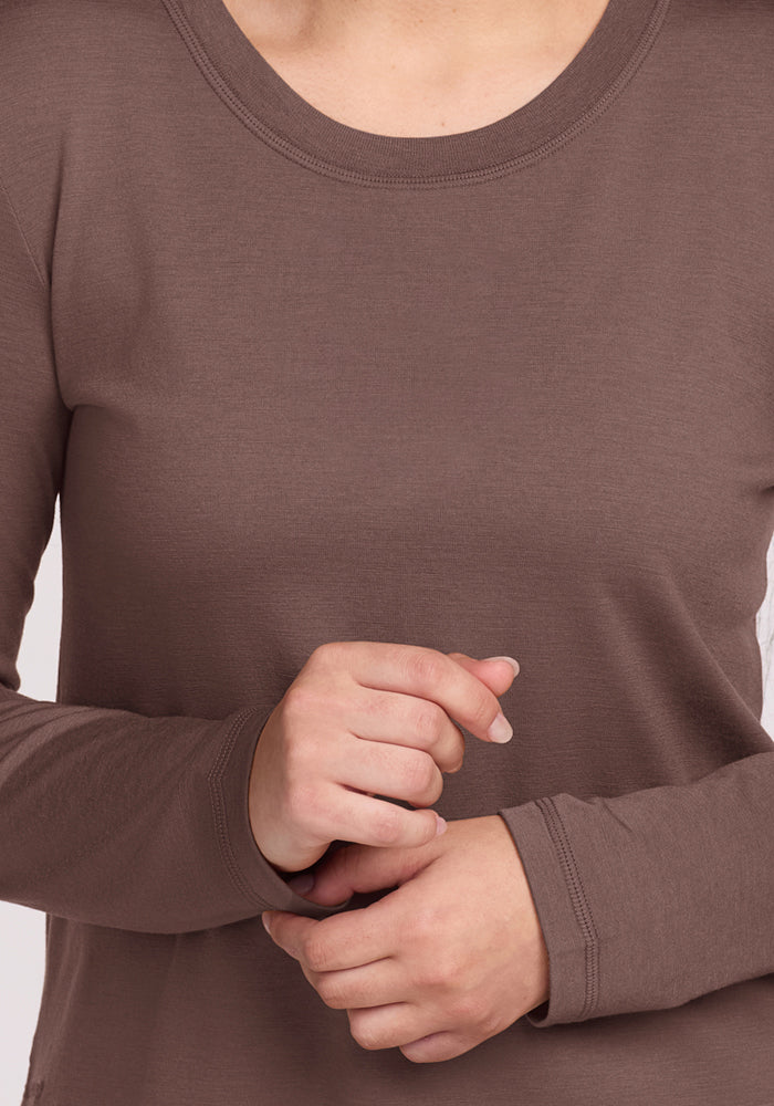 Person wearing the Woolx Hazel Tunic in Peppercorn; hands clasped at waist, head not shown.