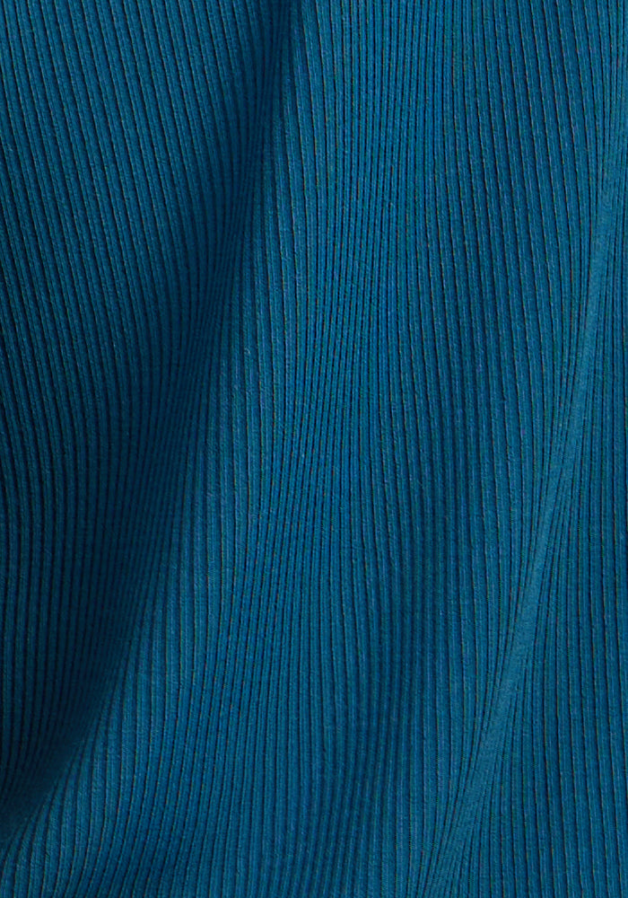 Close-up of Woolx Iris Ribbed Dress in Moroccan Blue with vertical textured lines and soft folds.
