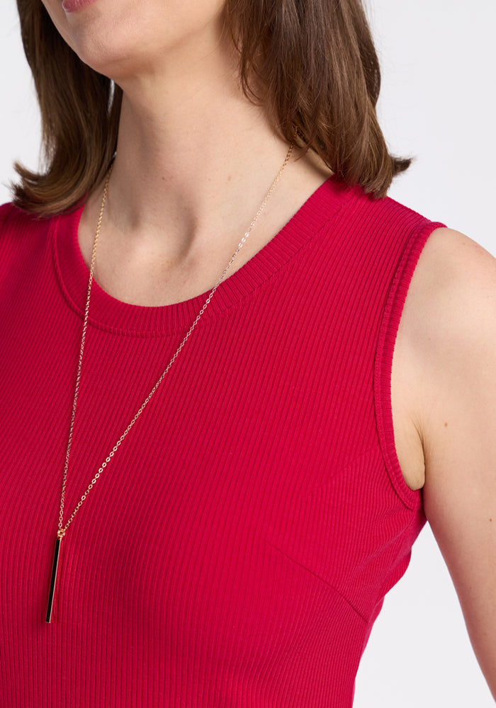 Woman wearing Woolx Iris Ribbed Dress in Poppy Spark, shown from shoulders up with gold necklace. Final Sale.