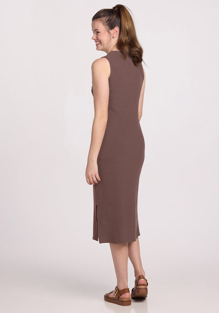Woman in the Woolx Iris Ribbed Dress in Peppercorn, sleeveless, standing and smiling, facing away.