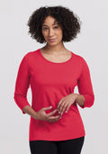 A person with curly hair in a Woolx Jenny 3/4 Sleeve Crew Neck - Berry Ice Pop, against a plain light background. | Tori is 5'7", wearing a size S