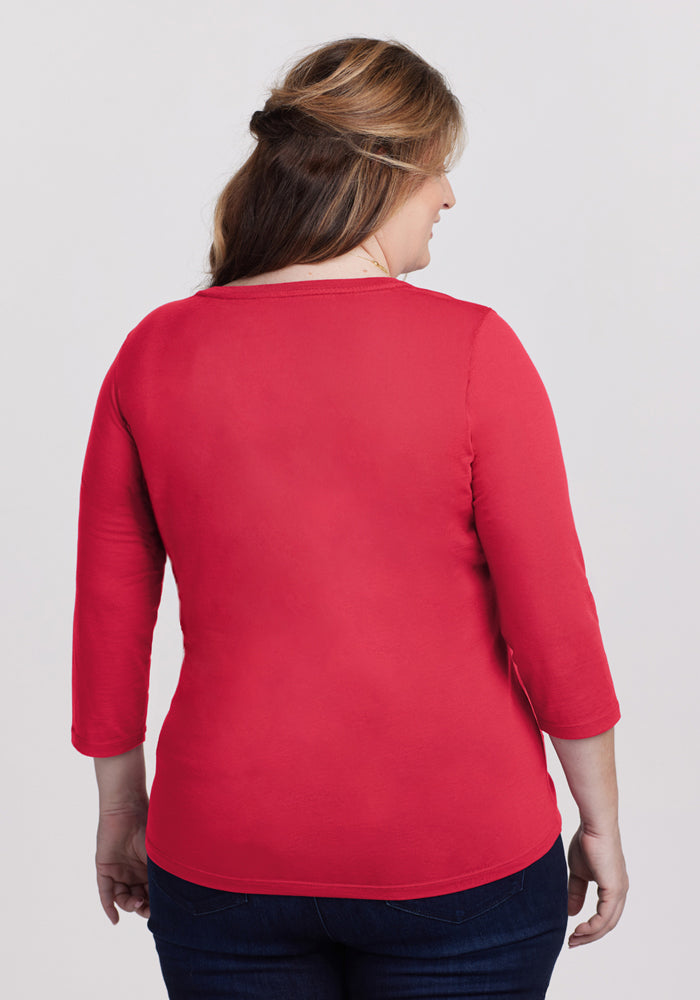 Woman with light brown hair in a Woolx Jenny 3/4 Sleeve Crew Neck - Berry Ice Pop, shown from the back with dark jeans.