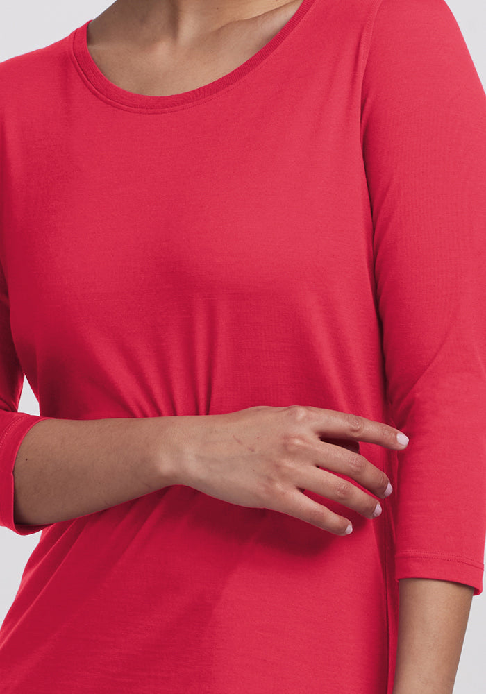 Someone wears the Woolx Jenny 3/4 Sleeve Crew Neck in Berry Ice Pop, one arm crossed over their torso.