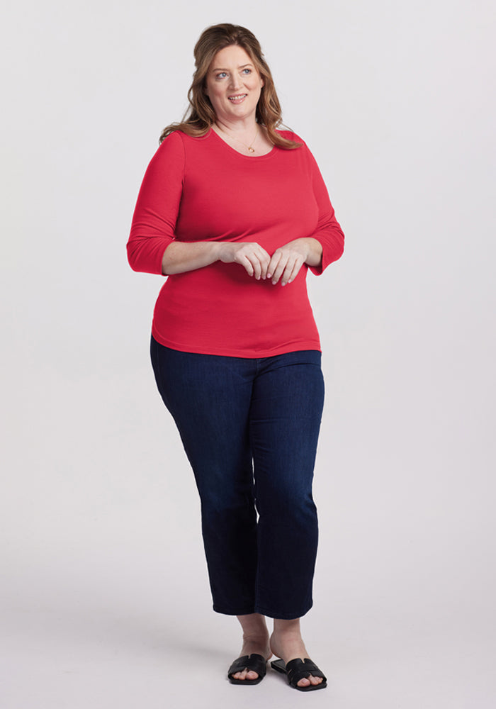 Woman in a Woolx Jenny 3/4 Sleeve Crew Neck - Berry Ice Pop shirt, dark jeans, and black sandals smiling.