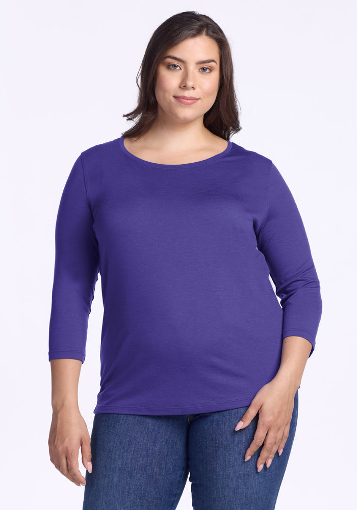 Woman in a Woolx Jenny 3/4 Sleeve Crew Neck - Berry Indigo and blue jeans, standing against a white background. | Juliana is 5'10", wearing a size XL
