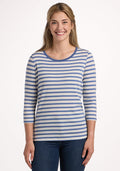 A smiling woman with long blonde hair models the Woolx Jenny 3/4 Sleeve Crew Neck in Blue Sand Stripe with blue jeans, standing against a plain white background. | Ariana is 5'11", wearing a size S