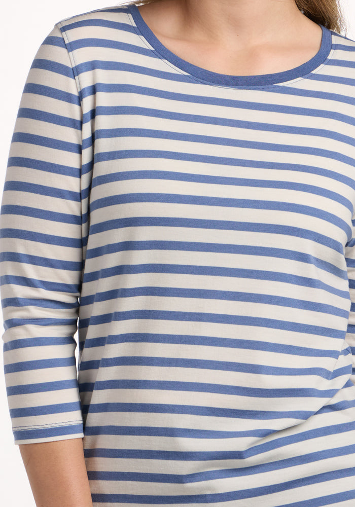 A person wearing the Woolx Jenny 3/4 Sleeve Crew Neck in Blue Sand Stripe, a lightweight Merino wool shirt with blue and white horizontal stripes, shown from shoulders to waist.