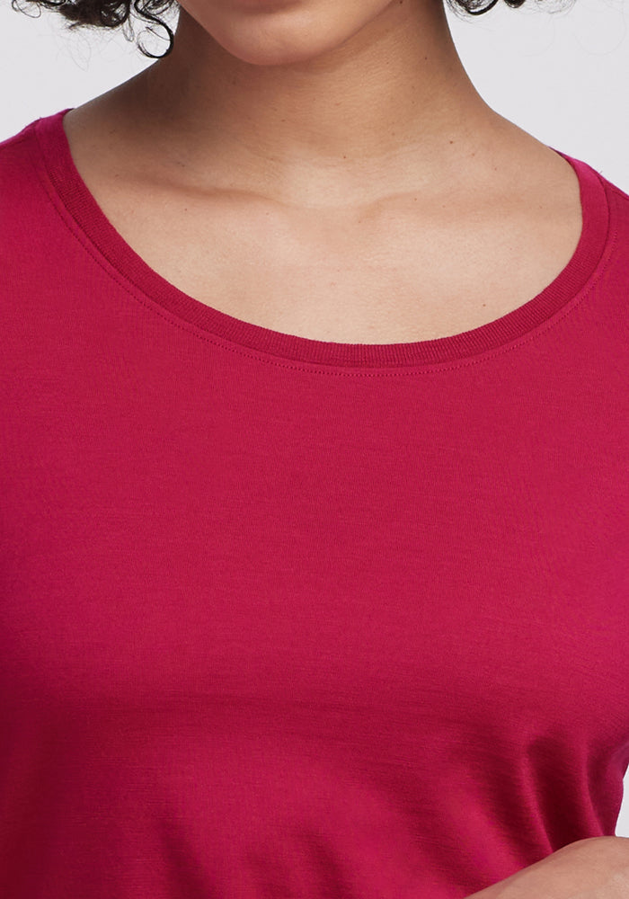A person wears the Woolx Jenny 3/4 Sleeve Crew Neck in Poppy Spark, shown from shoulders to upper chest.