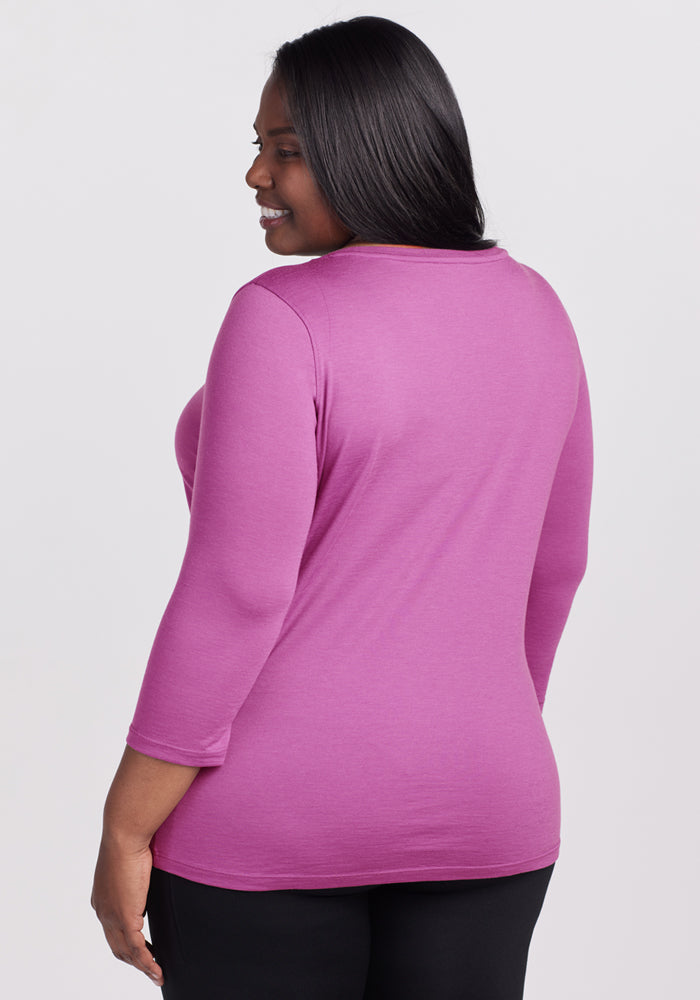 Woman with long dark hair wears the Woolx Jenny 3/4 Sleeve Crew Neck in Purple Wine, back to camera.