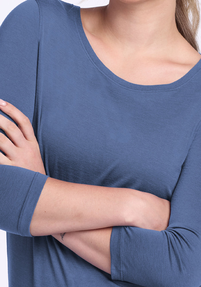Person wearing a Woolx Jenny 3/4 Sleeve Crew Neck in Skyline blue, arms crossed, shown shoulders to waist.