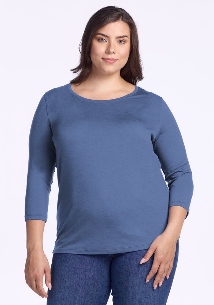 Woman with medium brown hair wearing a Woolx Jenny 3/4 Sleeve Crew Neck in Skyline and blue jeans against a white background.