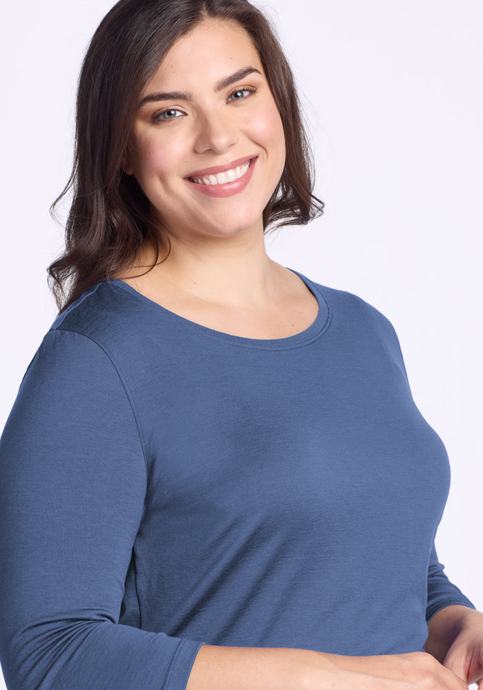 Smiling woman with long brown hair wears Woolx Jenny 3/4 Sleeve Crew Neck in Skyline against a light background.
