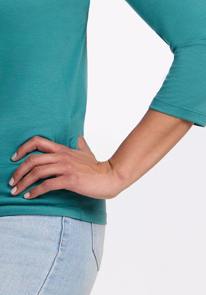 Person in a Woolx Jenny 3/4 Sleeve Crew Neck - Surfside, light jeans, hand on hip against a white background.