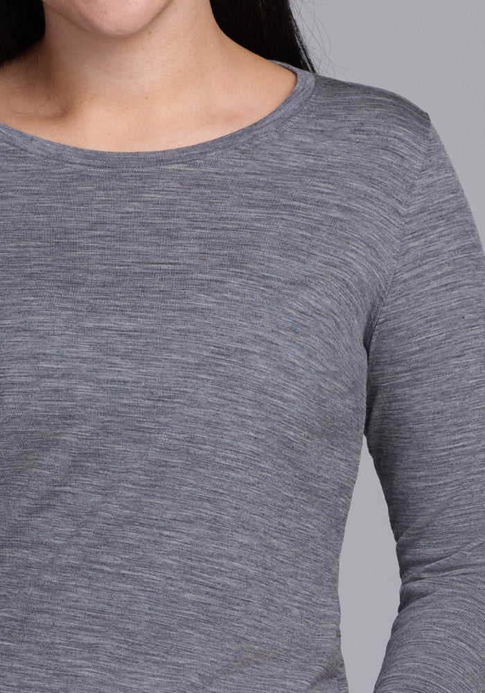 A person wearing a Woolx Jenny 3/4 Sleeve Crew Neck in Graphite Heather. The image focuses on the upper torso, with the face partially visible and no background details.