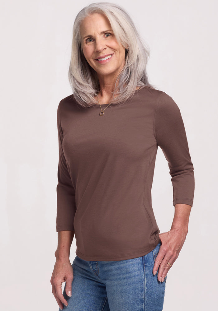 Smiling older woman in Woolx Jenny 3/4 Sleeve Crew Neck - Peppercorn, with blue jeans, against a light background. | Tam is 5’8.5”, wearing a size S