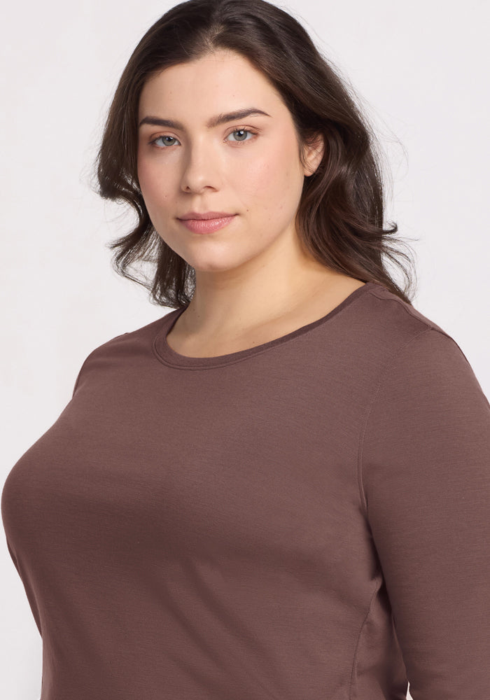 Woman with long brown hair wears Woolx Jenny 3/4 Sleeve Crew Neck in Peppercorn, looking at the camera.