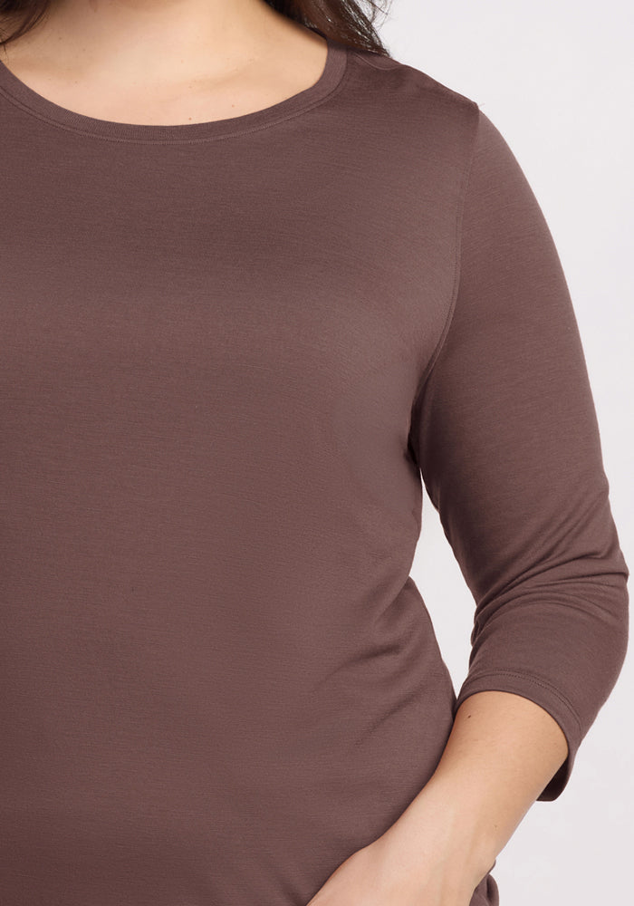 A person wearing the Woolx Jenny 3/4 Sleeve Crew Neck in Peppercorn, hand on hip, shown shoulders to waist.