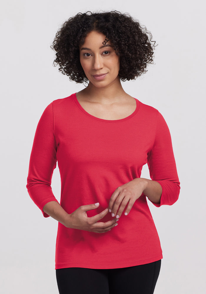 A person with curly hair in a Woolx Jenny 3/4 Sleeve Crew Neck - Berry Ice Pop, against a plain light background. | Tori is 5'7", wearing a size S