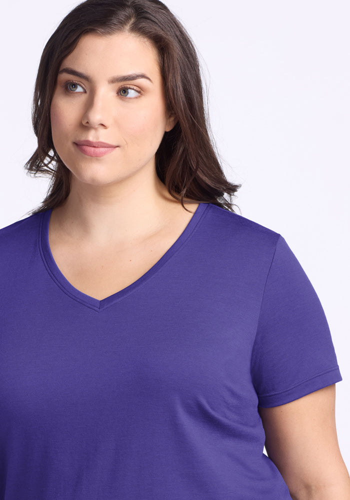 Woman with long brown hair wears the Woolx Junie V Neck - Berry Indigo, looking to the side against a light background.