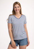 A smiling woman with long, light brown hair wears the Woolx Junie V Neck tee in Blue Sand Stripe and denim shorts, standing against a plain white background. | Ariana is 5'11", wearing a size S