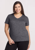 Smiling woman in a Woolx Junie V Neck tee in Cinder Melange and black pants, with long brown hair.