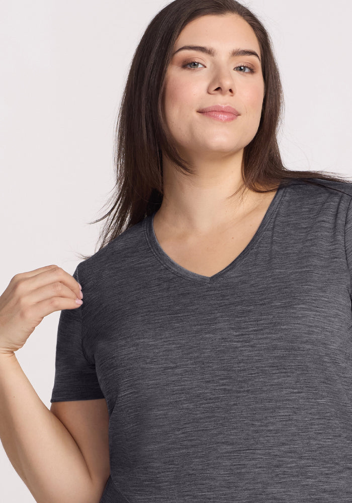 Woman with long dark hair wears Woolx Junie V Neck tee in Cinder Melange, short-sleeve, against a light background.