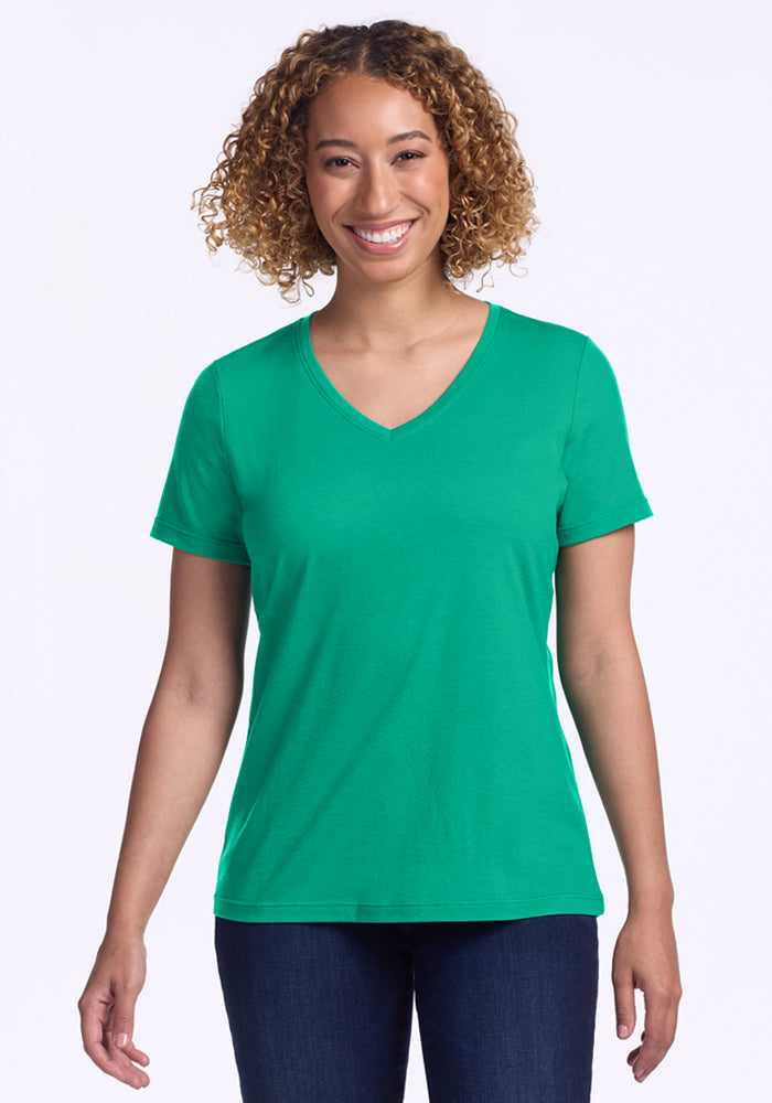 Smiling person in the Woolx Junie V Neck - Jungle, standing against a white background. | Tori is 5'7", wearing a size S