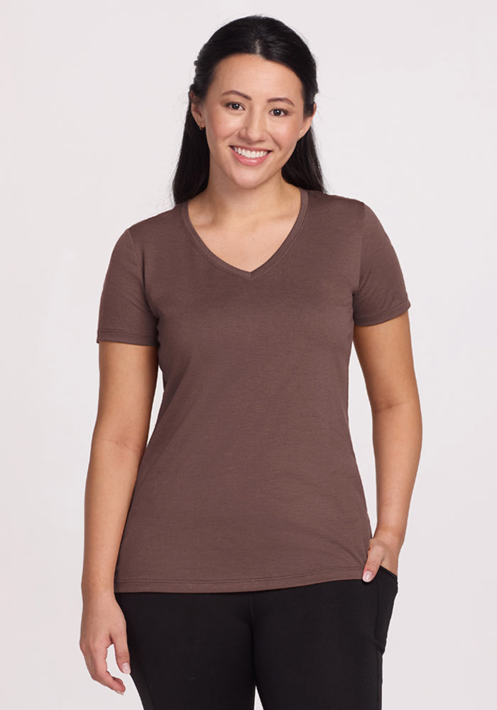 Woman with long dark hair wears the Woolx Junie V Neck - Peppercorn and black pants, smiling at the camera. | Sarah is 5'8", wearing a size S