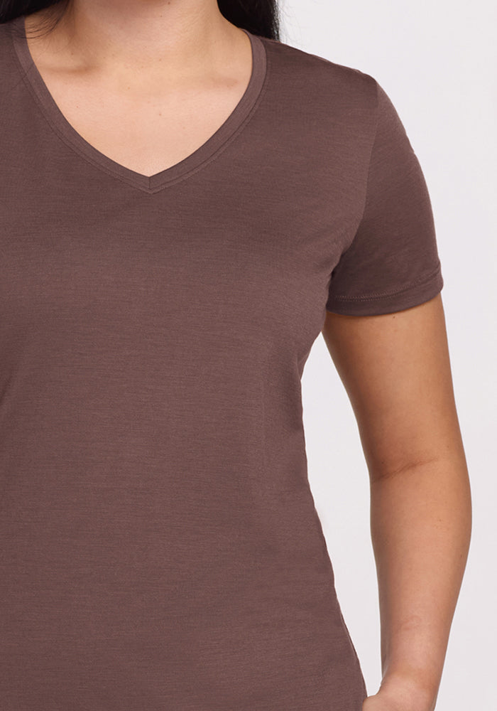 Person wearing Woolx Junie V Neck - Peppercorn, short sleeves, shown shoulders to hips against a plain background.