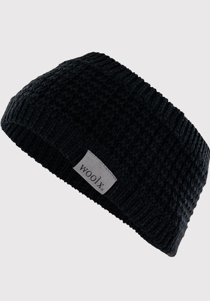 A black Merino wool knit accessory featuring a subtle pattern and a small label with the brand name "Woolx" on the side, displayed against a white background.