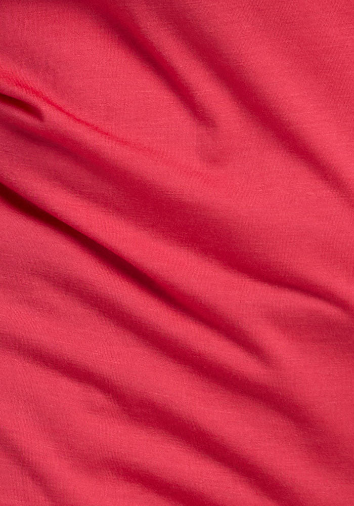 Close-up of the Woolx Layla V Neck Top in Berry Ice Pop with visible wrinkles and a soft, flowing texture.