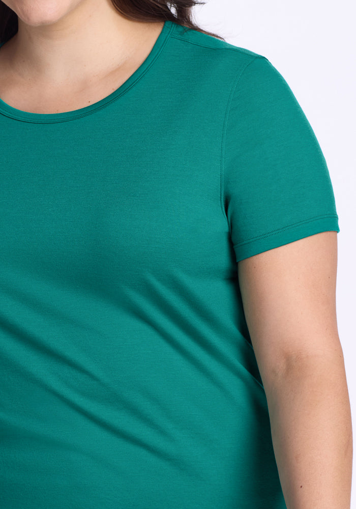 Woman in Woolx Liza Crew Neck Tee - Cabana Crush, short sleeves, shown shoulders to hip against a plain light background.