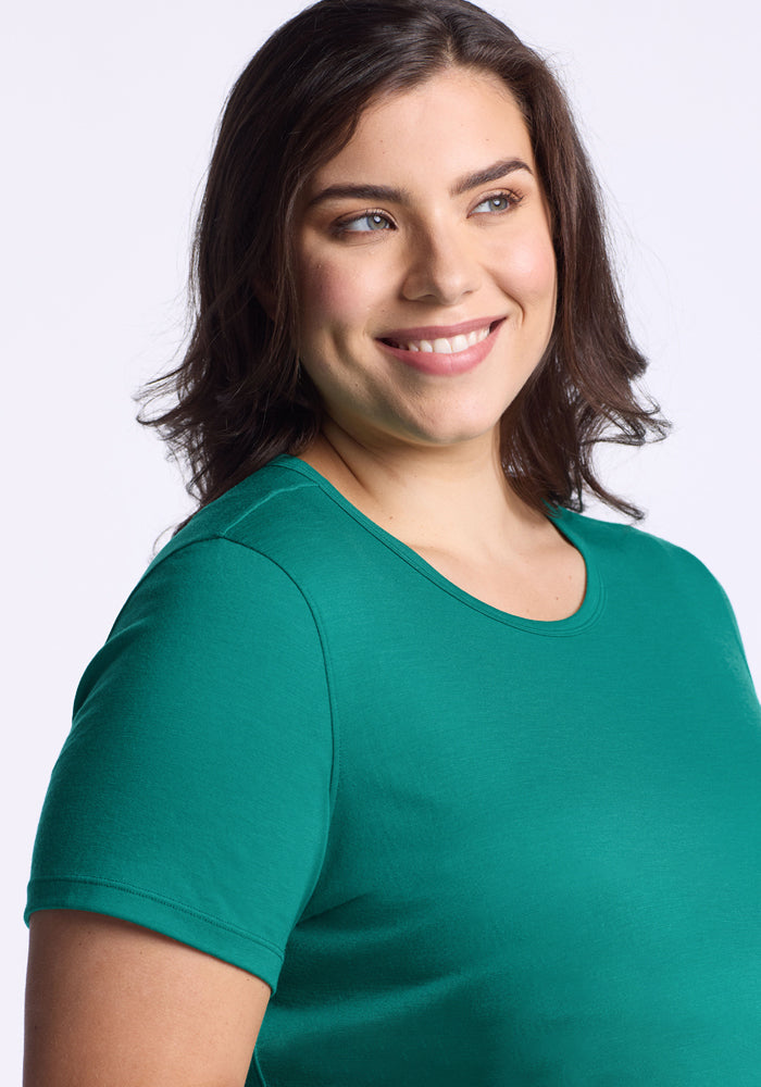Woman with brown hair wears the Woolx Liza Crew Neck Tee in Cabana Crush, smiling against a light background.
