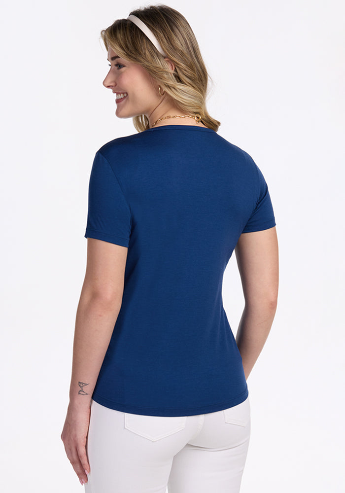 Woman in Woolx Liza Crew Neck Tee in Estate Blue, smiling and facing away from camera.