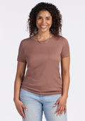 Smiling woman in Woolx Liza Crew Neck Tee • Final Sale - Sienna Kiss and jeans, standing against a white background.