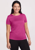 Smiling woman with long dark hair wears Woolx Liza Crew Neck Tee in Summer Sorbet and black pants, light background. | Sarah is 5'8", wearing a size S