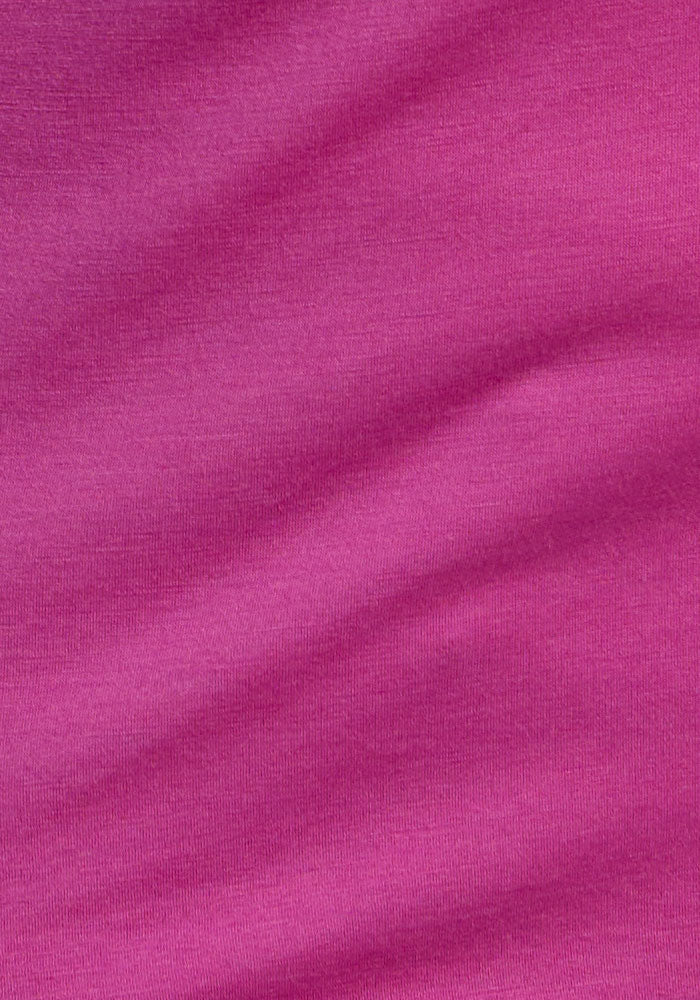 Close-up of Woolx Liza Crew Neck Tee in Summer Sorbet, showing textured magenta Australian merino wool fabric.