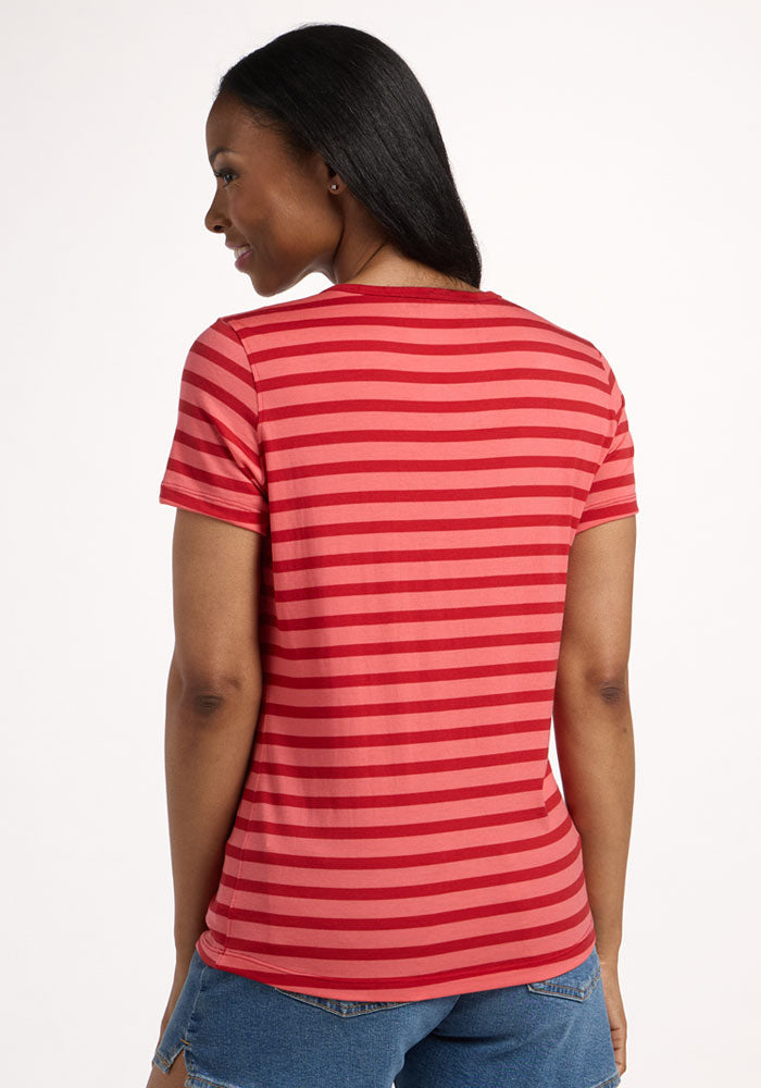 A woman with long dark hair, seen from behind, models the Woolx Liza Crew Neck Tee in Wildberry Stripe and blue denim shorts against a white background.