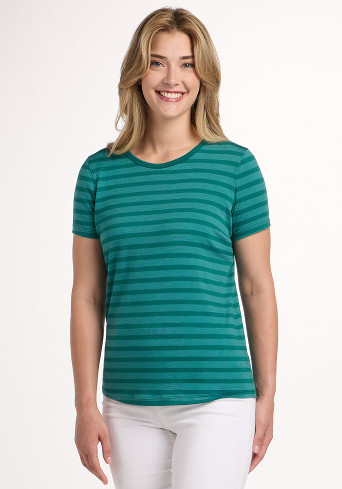 Smiling woman in a Woolx Liza Crew Neck Tee - Woodland Stripe and white pants stands against a plain white background. | Ariana is 5'11", wearing a size S