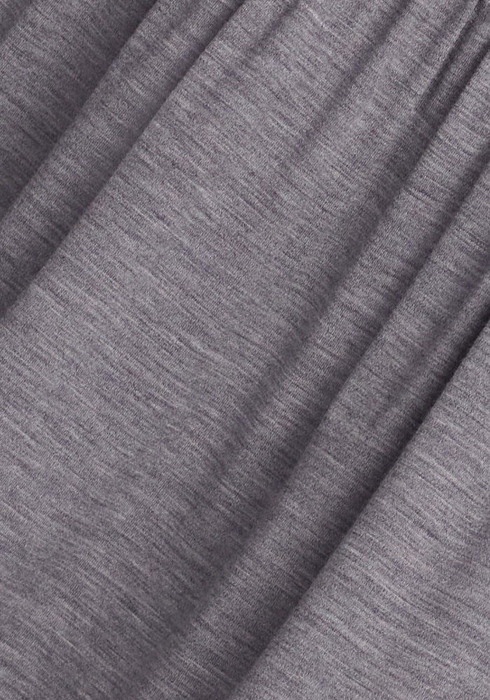 Close-up of the Woolx Lucia Dress in Graphite Heather, featuring a soft, stretchy texture with gentle folds and slight shading variations reminiscent of fine merino wool.