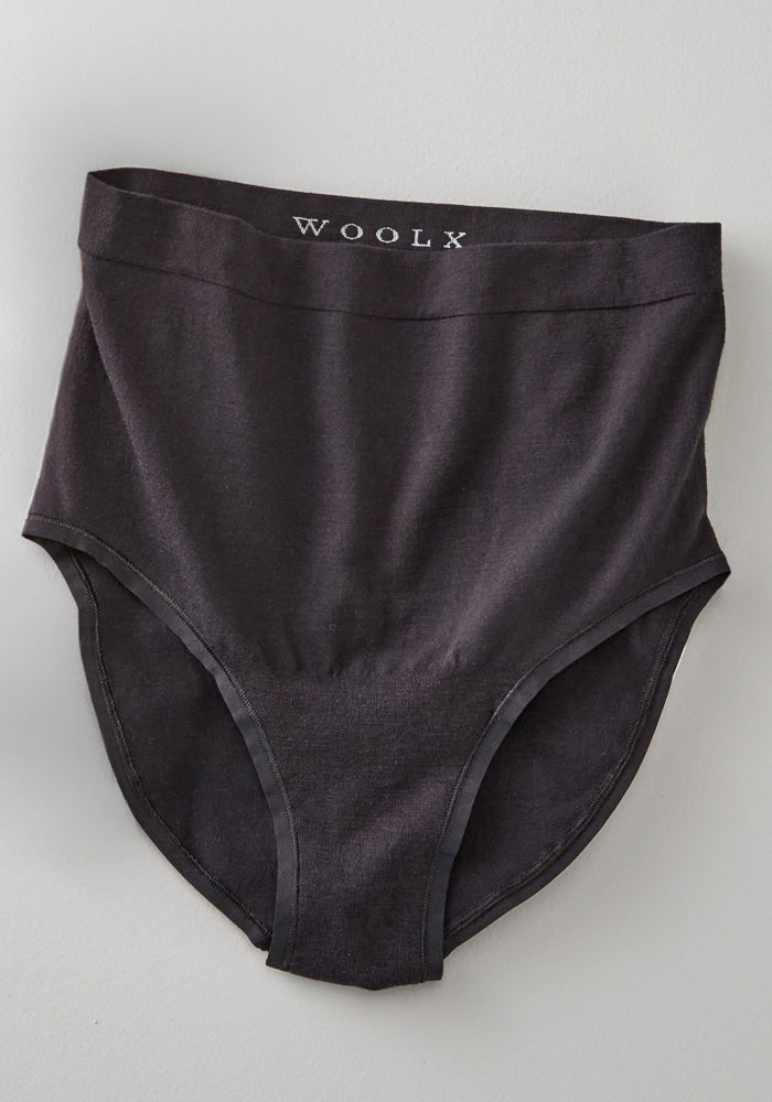 The Mabel Full Coverage Underwear by Woolx is a high-waisted, black merino wool women's underwear featuring a "WOOLX" waistband, shown against a light gray background.