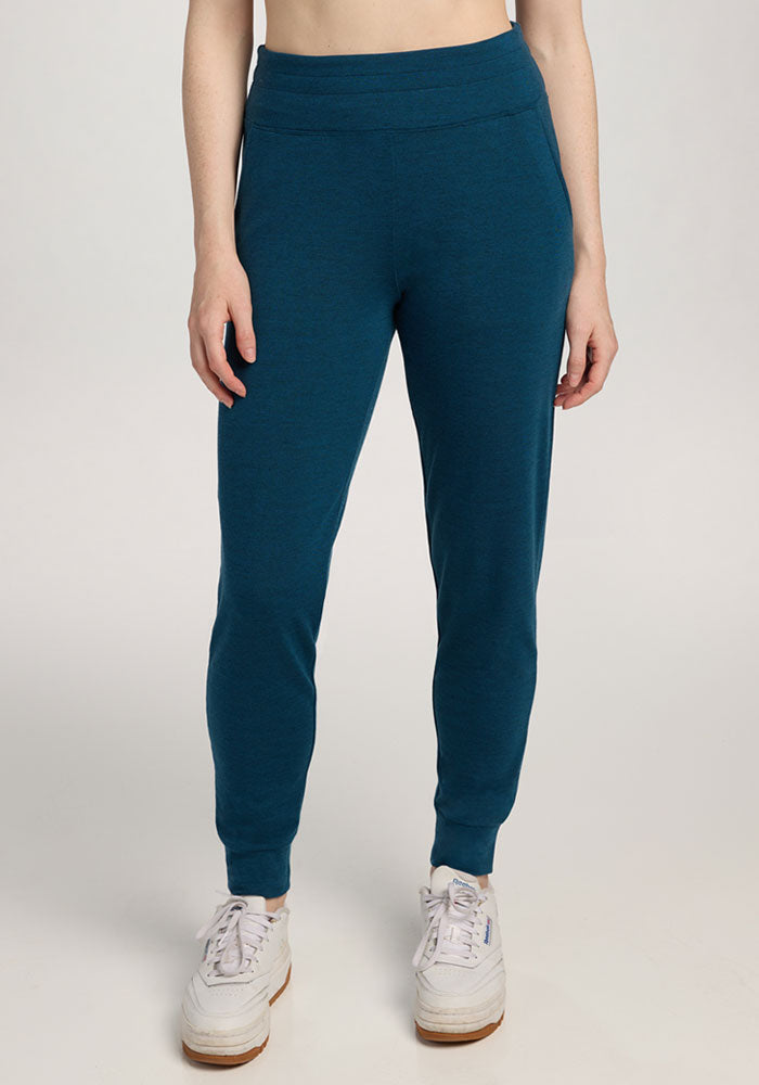 Person wearing Woolx Madden Joggers in Majolica Blue and white sneakers, standing against a plain light background. | Shea is 5'9", wearing a size S