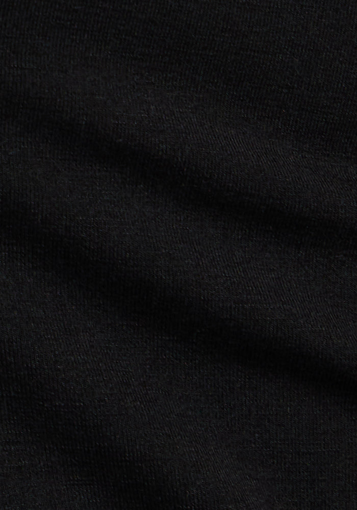 Close-up of the Woolx Madden Petite Joggers in Black, showing soft merino wool fabric with subtle horizontal folds and delicate knit texture, creating a smooth, refined look perfect for women's joggers.
