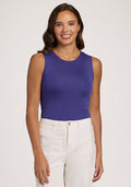 Woman with wavy brown hair smiles, wearing the Woolx Maggie Bodysuit in Berry Indigo against a light background. | Madeleine is 5’10”, wearing a size XS