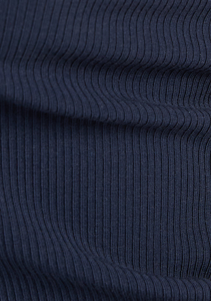 Close-up of Woolx Maisey Ribbed Shorts in Deep Navy, featuring vertical textured lines and subtle waves.
