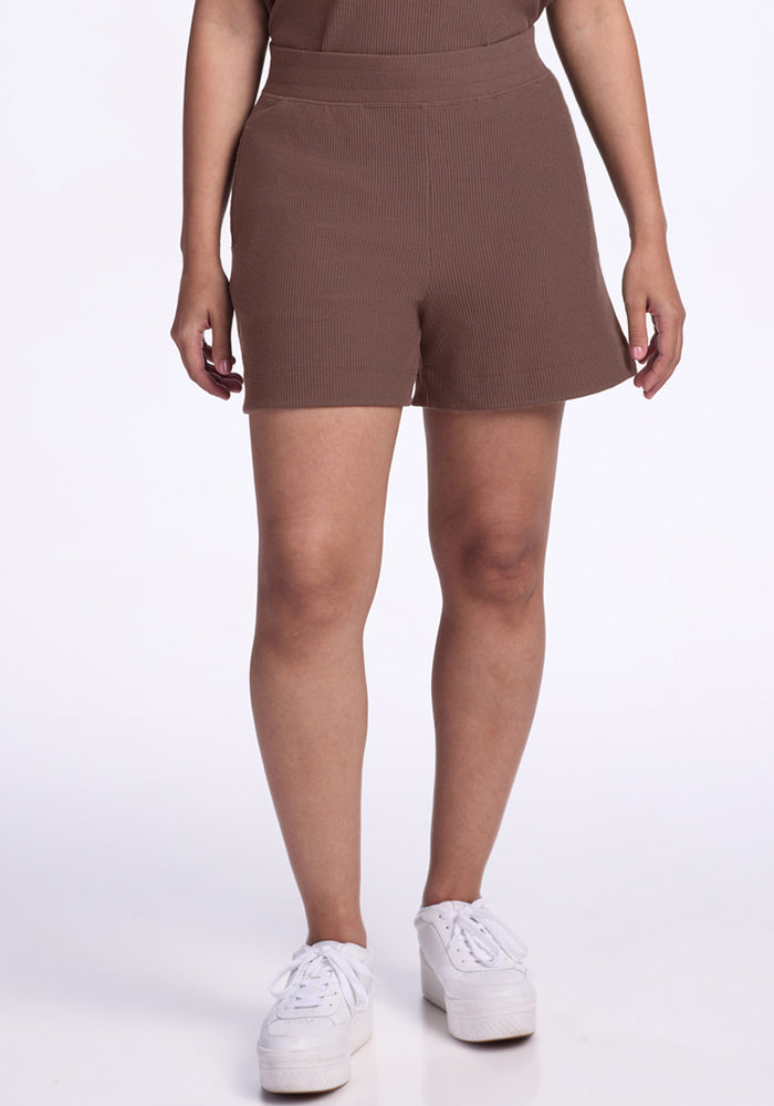 Someone wearing Woolx Maisey Ribbed Shorts in Peppercorn and white platform sneakers against a plain white background. | Tori is 5'7", wearing a size S