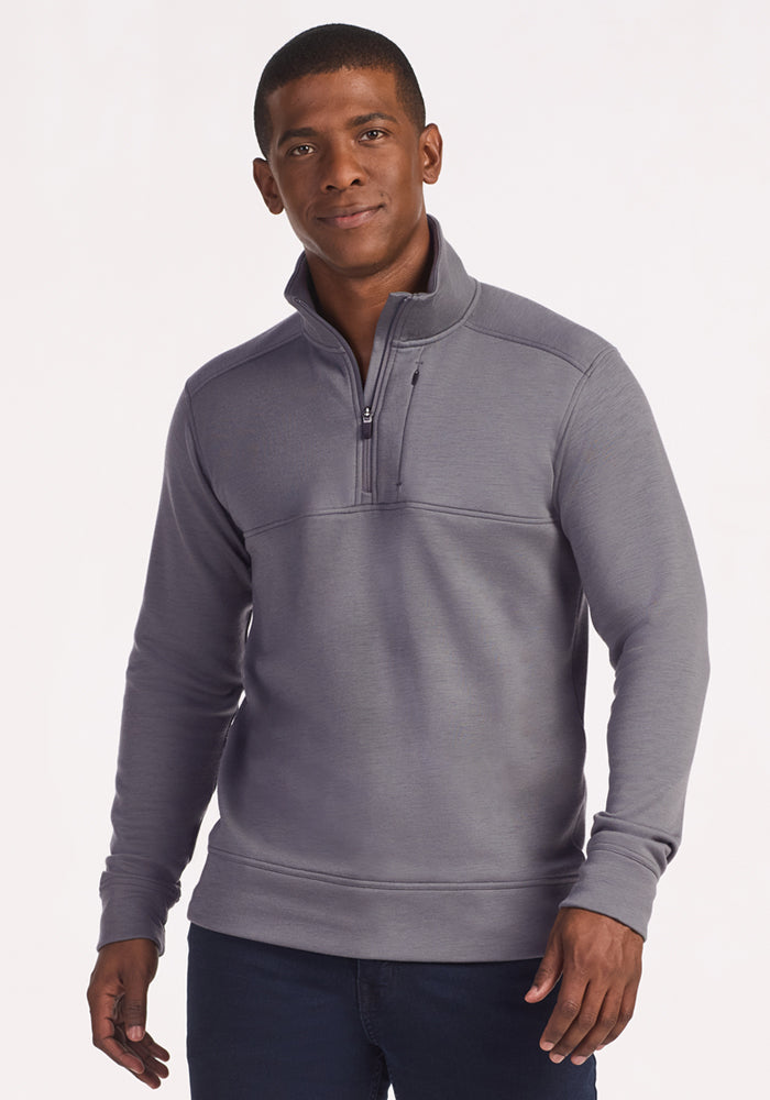 A man faces forward in a Woolx Mason 1/4 Zip • Final Sale - Arctic Dusk pullover and dark jeans, wearing a neutral expression against a plain white background.