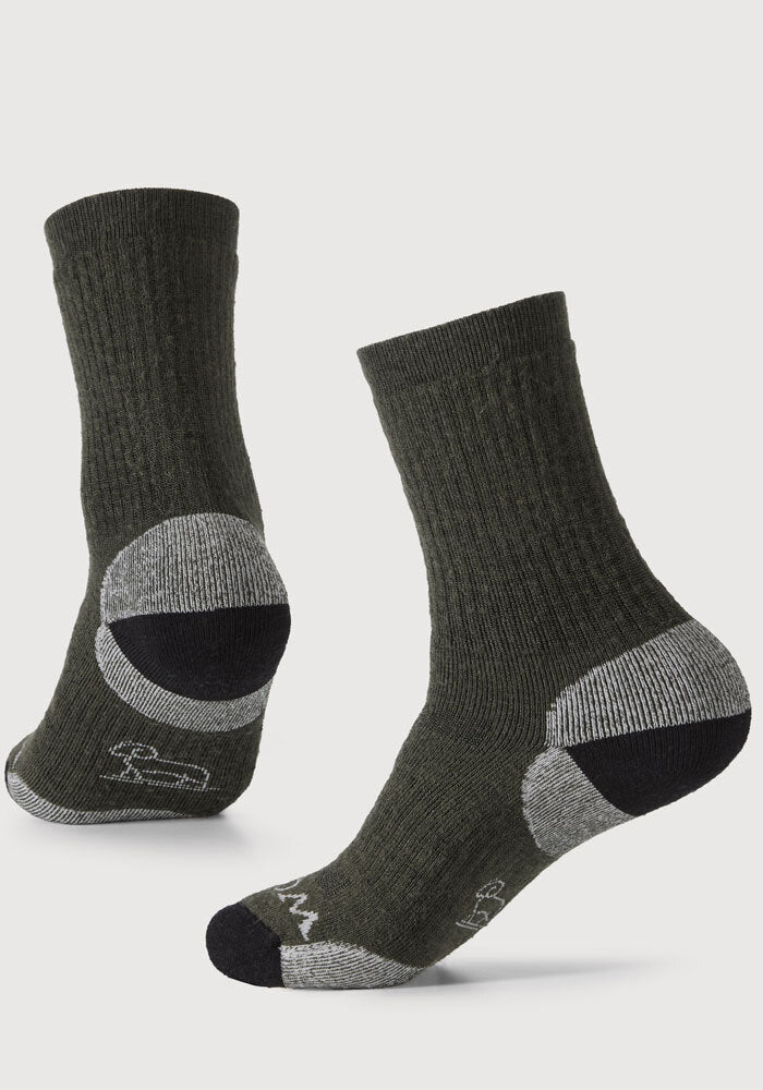 Introducing the Everyday Crew Sock Medium Cushion - Deep Forest by Woolx, a pair of dark green, mid-calf socks crafted from Merino Wool. These socks feature gray and black reinforced areas on the heels, toes, and arches for added durability. They boast superior moisture-wicking properties and arch support. The presentation includes one sock standing upright while the other is tilted to display both the tops and bottoms.