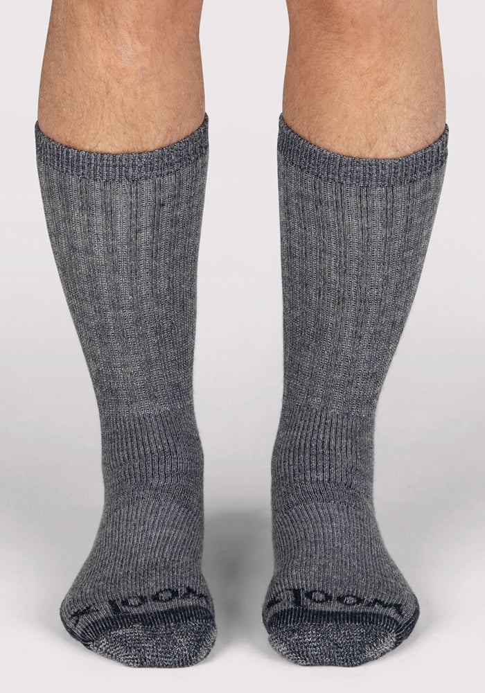 A pair of feet wearing Woolx Mens Extreme Crew Socks in Charcoal Heather, heavyweight merino wool, ribbed, shown from the front on a plain white background.